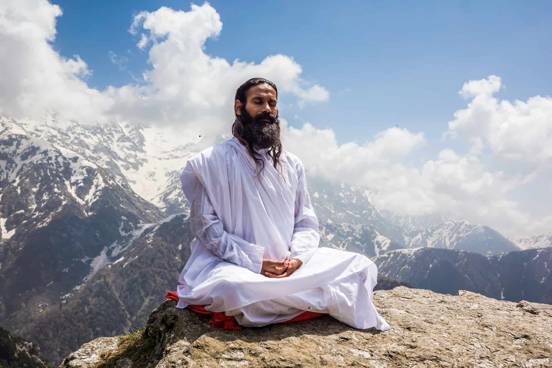 a man meditates on the mountain