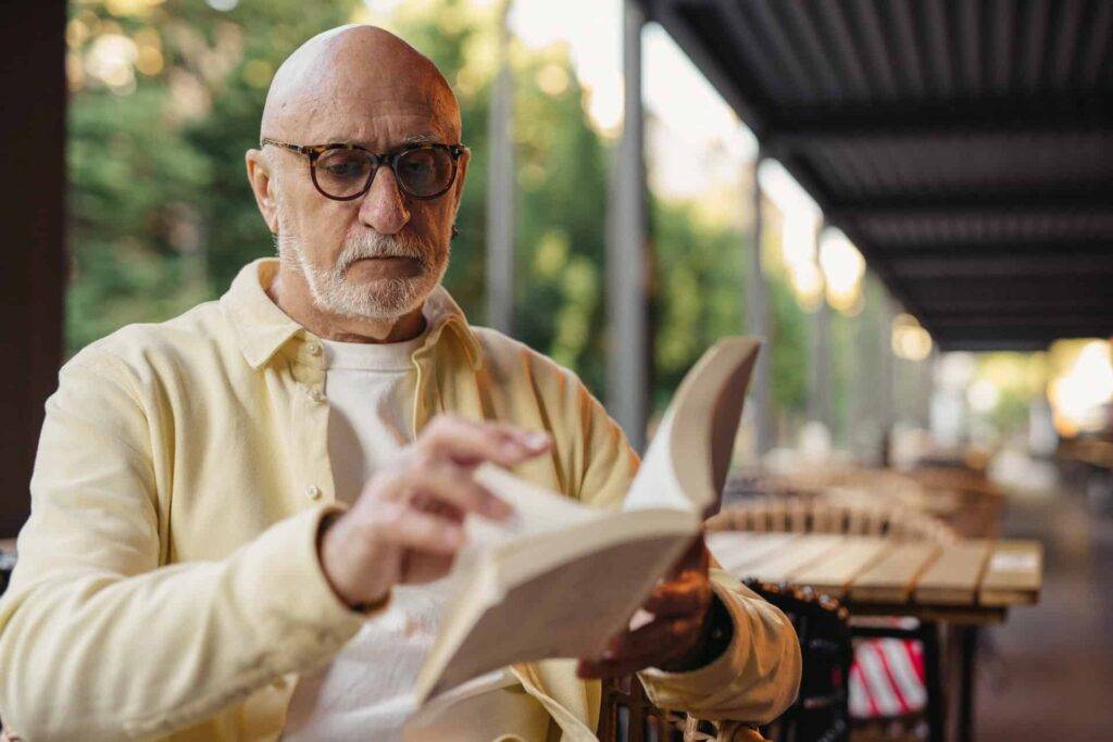 Elderly Man Reading a Book as a Hobby