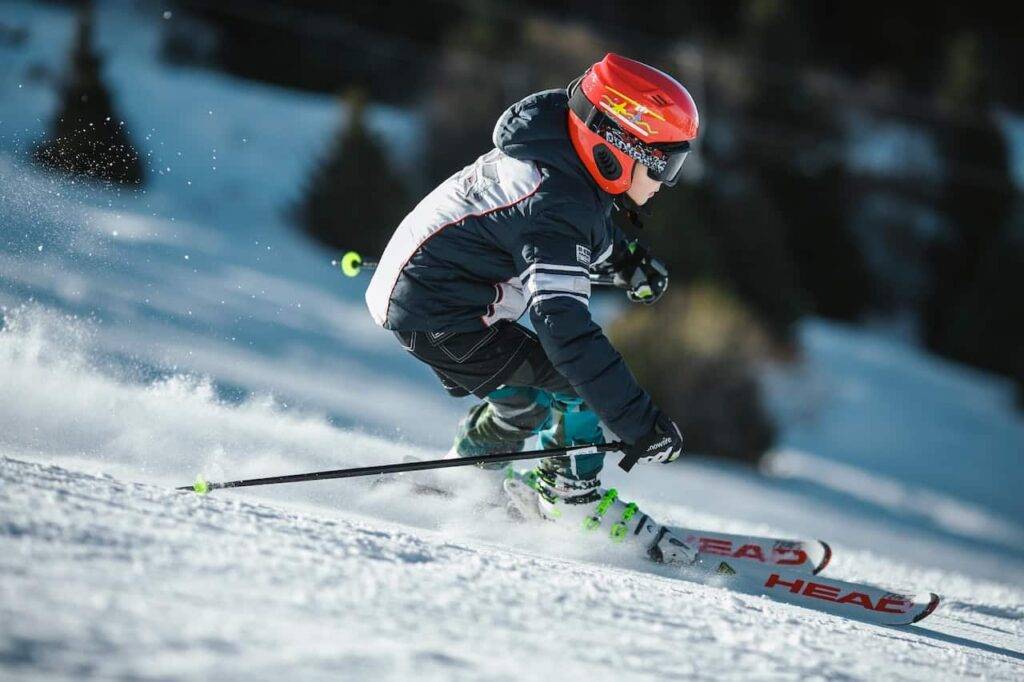 skier carving turns down a snowy slope